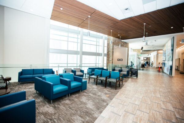 A Room Filled With Furniture And A Blue Chair